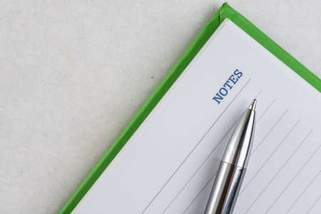Flat lay above business notes with pen on the white marble.