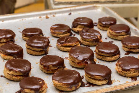 Fresh chocolate cookies with topping cream.
