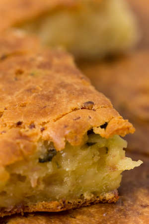 Macro view of homemade pie with ham cheese and cucumber.