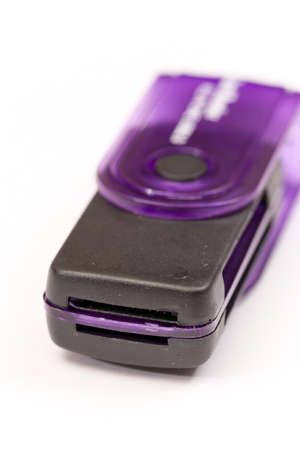 Black plastic memory card reader over white.