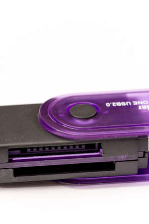 Black plastic memory card reader over white.
