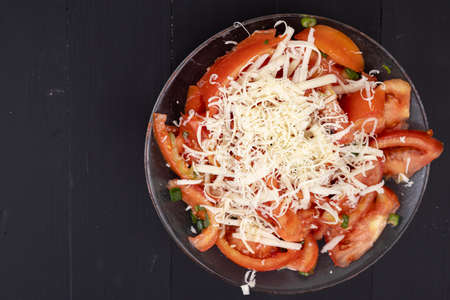 Top view of Tomato salad with onions and cheese with copy space.の写真素材