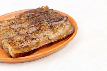 Sliced stripes of grilled bacon served on the plate.の写真素材