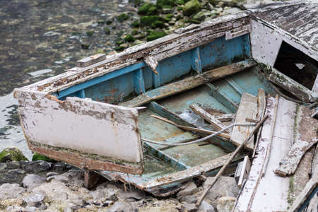 Crashed wooden sea aground on the sea beach.