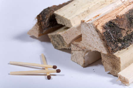 Firewood with matches over white background.