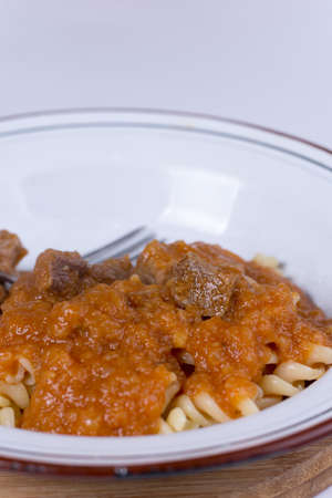 Served beef stew with macaroni in the metal plate.の写真素材