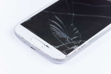 Crashed lcd on the white mobile phone.の写真素材
