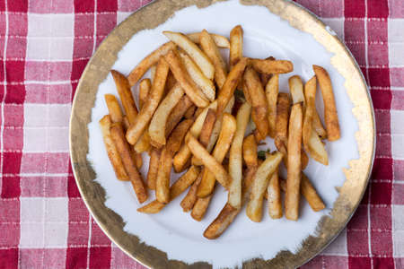 Top view of plate with fresh fryed french fries.
