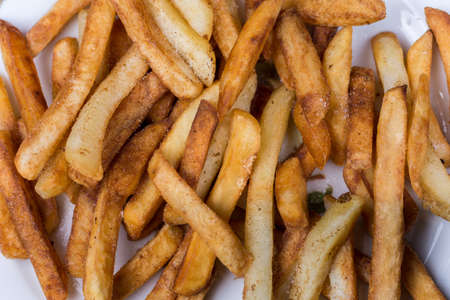 Close macro view of french fries on the plate.