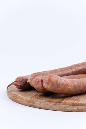 Raw sausages on the cutting board.