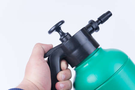 Plastic water pump in hand over white background.