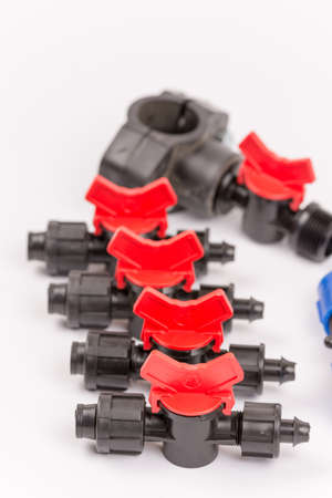 Pile of irrigation tools and valves over white.
