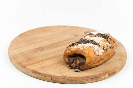 Chocolate croissant on a wooden board.の写真素材