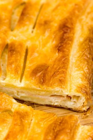 Sliced pastry with cheese and meat.の写真素材