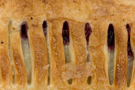 Close macro view of pastry with cherry cream.