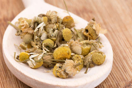 Close macro view of chamomile tea in the spoon.の写真素材