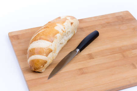 Bread loaf with kitchen knife.の写真素材
