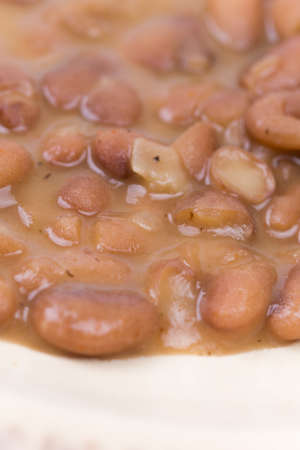 Closeup macro cooked beans on the plate.