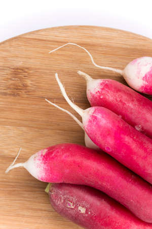 Pile of red radishes on the board.の写真素材