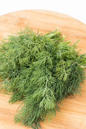 Fresh dill on the wooden kitchen board