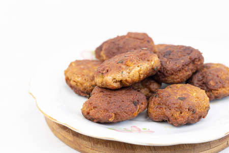 Fried meatballs served on the plate with white background.