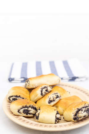 Poppy seeds cookies served on the plate with copy space above white background.の写真素材