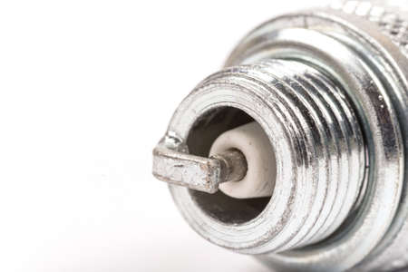 Spark plug over white background with copy space