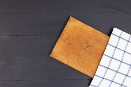 Flat lay copy space wooden cutting board kitchen dishtowel food concept dark background.の写真素材