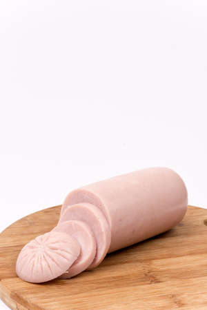 Sliced pork bologna salami on the wooden boardの写真素材
