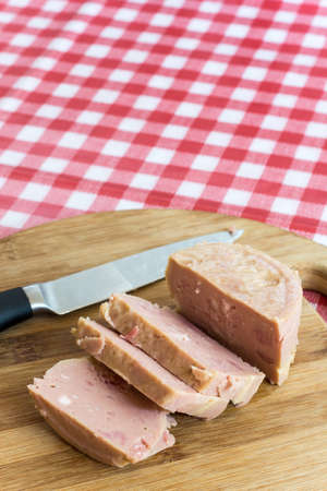 Luncheon meat on the wooden board with blurred backgroundの写真素材