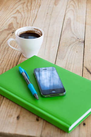 Business notes with pen mobile phone and cup of coffeeの写真素材