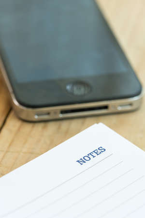 White note with notes word over rustic wooden backgroundの写真素材