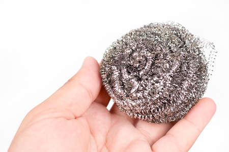 Cleaning wire in the hand over white backgroundの写真素材