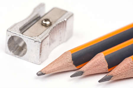 Wooden pencils with metal sharpener over white backgroundの写真素材