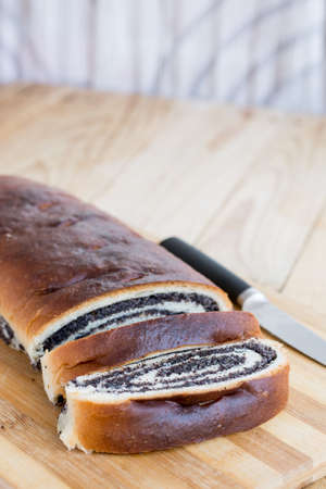 Strudel with poppy seeds on the wooden retro table