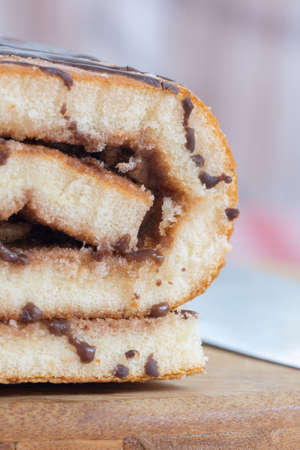 Chocolate roll cake on the wooden boardの写真素材