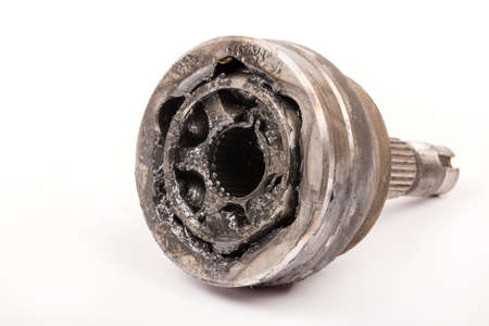 Old used oiled CV joint over white background