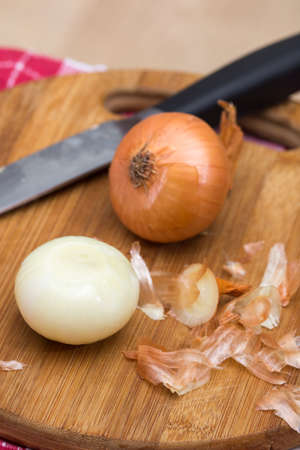 Onions on the wooden cutting boardの写真素材