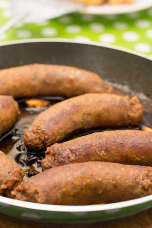 Fried homemade sausages in the frying panの写真素材