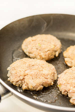 Frying meatballs of minced meat with onions in the frying panの写真素材