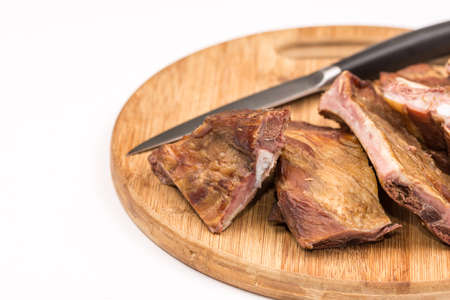 Smoked ribs on the wooden board with kitchen knifeの写真素材