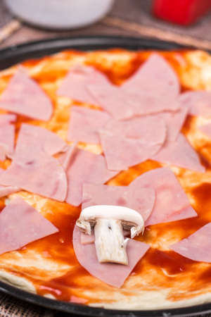 Pizza with ham ketchup and mushroomの写真素材
