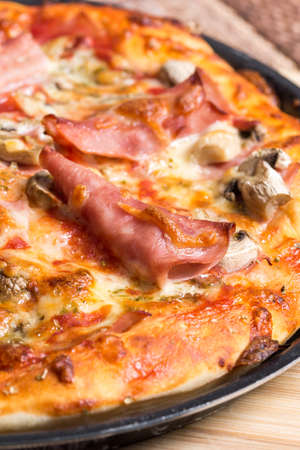 Delicious pizza with ham cheese mushroomsの写真素材