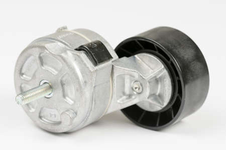 Car belt tensioner roller isolated over whiteの写真素材