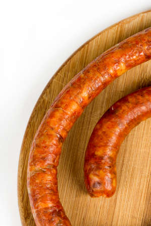 Raw homemade domestic sausage on the wooden board. Flat lay with copy space.