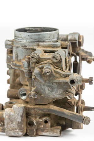 Old used dirty carburetor over white background