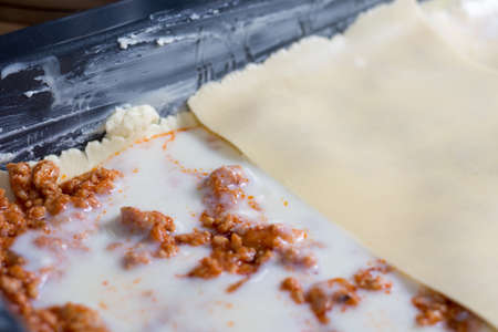 Bechamel sauce with stewed meat and preparing lasagnaの写真素材