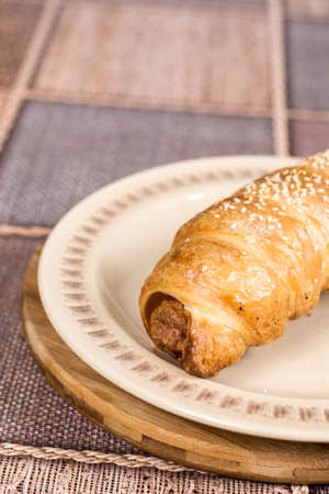 Puff pastry stuffed with sausages on the plateの写真素材