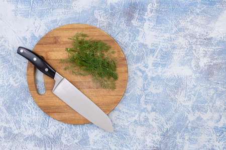 Top view of fresh dill on the cutting wooden board.