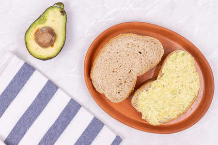Bread with Avocado spread served on the plate.